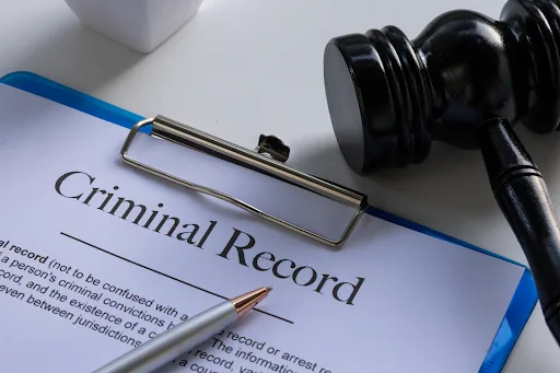 Gavel beside a criminal record form